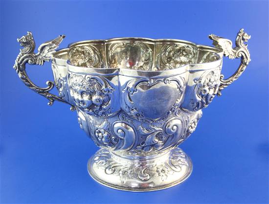 A late Victorian repousse silver two handled punch bowl, 35 oz.